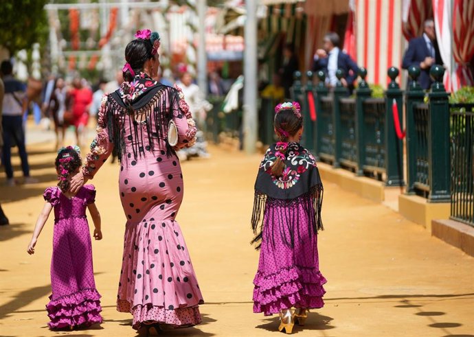 Archivo - Mujeres vestida de flamenca en la feria. A 18 de abril de 2024, en Sevilla (Andalucía, España). Ambiente en el real de la feria de Abril.