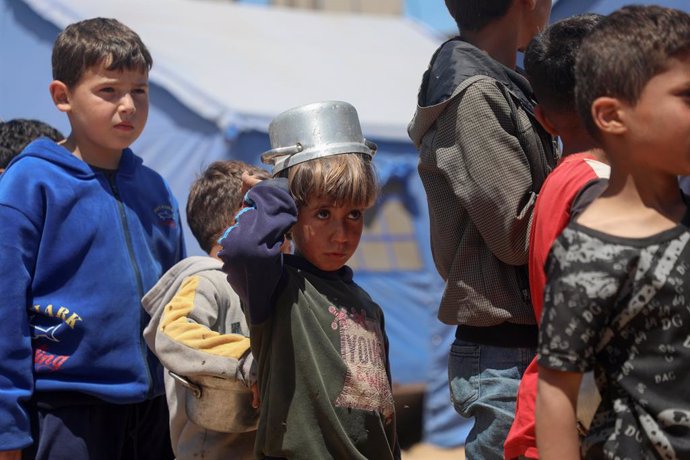 GAZA, April 20, 2025  -- Palestinian children wait to receive free food from a food distribution center in Gaza City, on April 19, 2025. The United Nations Relief and Works Agency for Palestine Refugees in the Near East (UNRWA) said in a statement on Satu