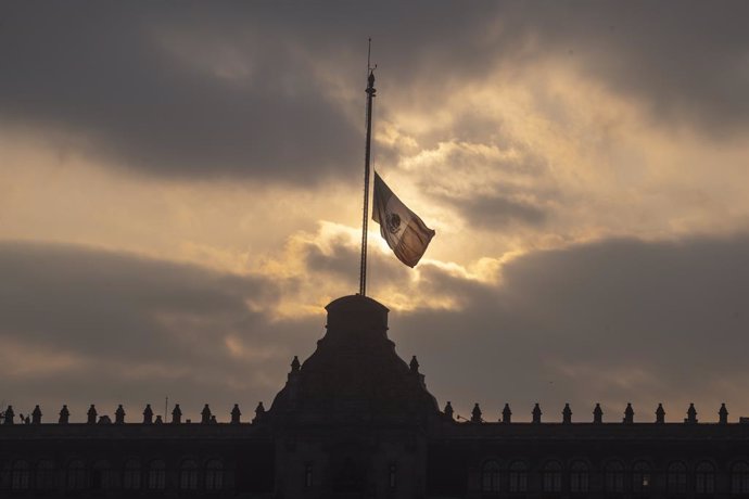 Mexico, Mexico City: The Mexican flag flies at half-mast in front of the National Palace in Mexico City