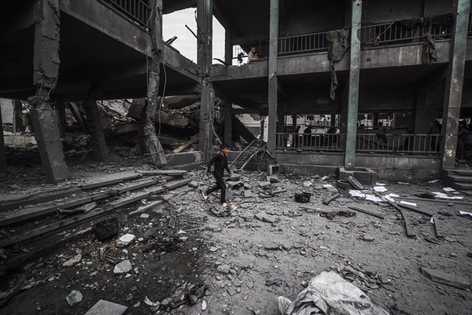 GAZA, May 12, 2025  -- Palestinians inspect a damaged school after an Israeli airstrike in the Jabalia refugee camp, northern Gaza Strip, May 12, 2025.