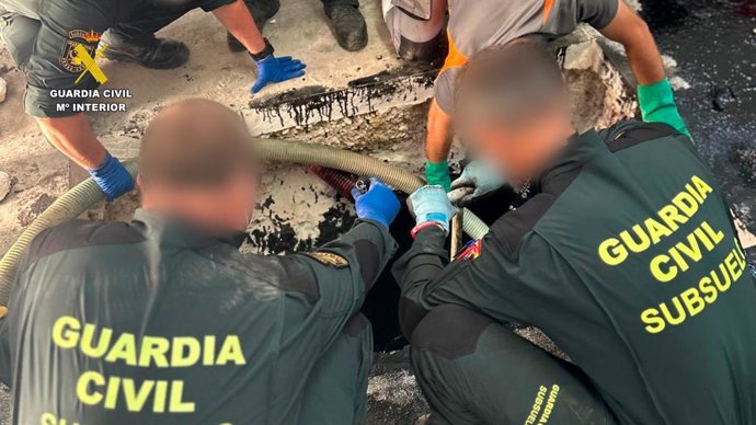 Archivo - Efectivos de la Guardia Civil vaciando el depósito de aceite