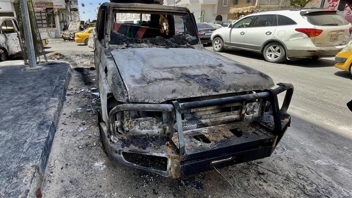 Vista de un vehículo dañado durante los enfrentamientos entre milicias en Trípoli, Libia