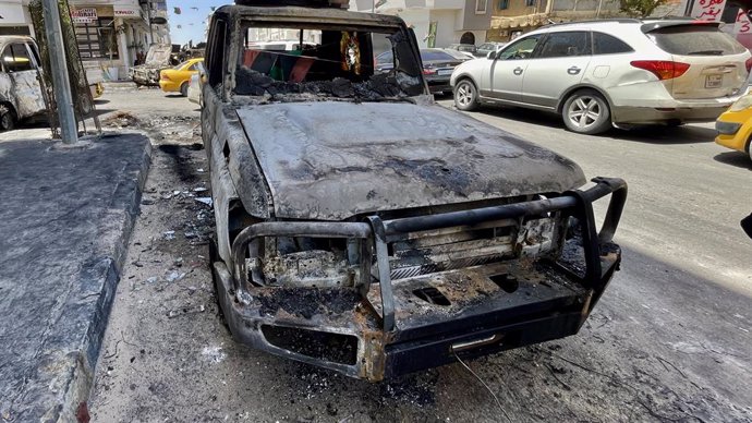 TRIPOLI, May 13, 2025  -- This photo shows a car damaged during violent clashes on a street in Tripoli, Libya on May 13, 2025. Overnight violent clashes in the Libyan capital Tripoli killed at least six people, an emergency medical service said Tuesday.  