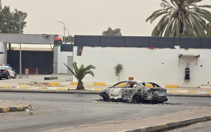 TRIPOLI, May 14, 2025  -- This photo taken on May 14, 2025 shows a car damaged during violent clashes on a street in Tripoli, Libya. Libya's Tripoli-based Government of National Unity (GNU) declared a ceasefire on Wednesday following intense overnight cla