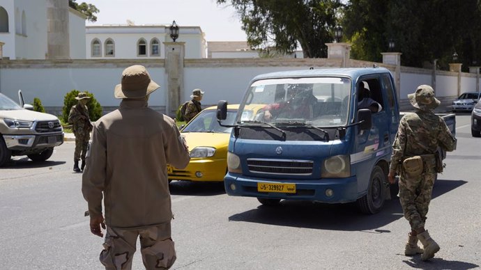 TRIPOLI, May 13, 2025  -- The security personnel of the Libyan government maintain order on a street in Tripoli, Libya on May 13, 2025. Overnight violent clashes in the Libyan capital Tripoli killed at least six people, an emergency medical service said T