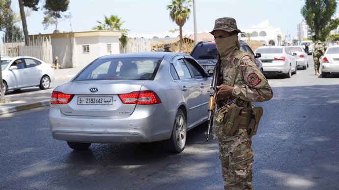 TRIPOLI, May 13, 2025  -- The security personnel of the Libyan government maintain order on a street in Tripoli, Libya on May 13, 2025. Overnight violent clashes in the Libyan capital Tripoli killed at least six people, an emergency medical service said T