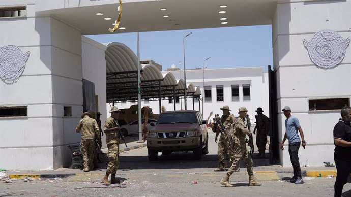 TRIPOLI, May 13, 2025  -- The security personnel of the Libyan government maintain order on a street in Tripoli, Libya on May 13, 2025. Overnight violent clashes in the Libyan capital Tripoli killed at least six people, an emergency medical service said T