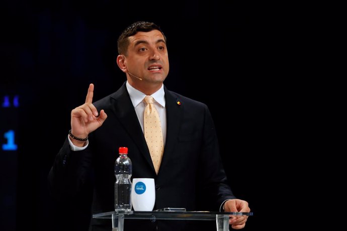 BUCHAREST, May 9, 2025  -- George Simion, chairman of the Alliance for the Union of Romanians, gestures during a TV debate with Bucharest Mayor Nicusor Dan (not in picture) in Bucharest, Romania, May 8, 2025. George Simion and Nicusor Dan will advance to 