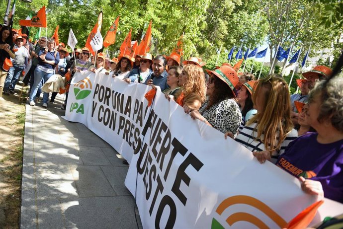 Varias personas con una pancarta durante una concentración de agricultores convocada por la Unión de Pequeños Agricultores y Ganaderos (UPA), frente a la sede de la Unión Europea en Madrid, 