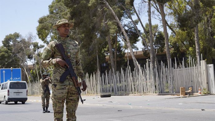TRIPOLI, May 13, 2025  -- The security personnel of the Libyan government maintain order on a street in Tripoli, Libya on May 13, 2025. Overnight violent clashes in the Libyan capital Tripoli killed at least six people, an emergency medical service said T