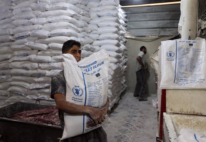 May 22, 2025, Deir Al-Balah, Gaza Strip, Palestinian Territory: Workers package bread for distribution at the World Food Programme (WFP) bakery after a limited amount of flour entered the Gaza Strip, where border crossings have remained closed since March