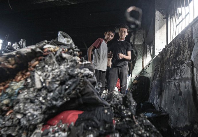 Niños palestinos inspeccionan los daños tras un ataque aéreo israelí contra una escuela que alberga desplazados, en Ciudad de Gaza, el 20 de mayo de 2025.