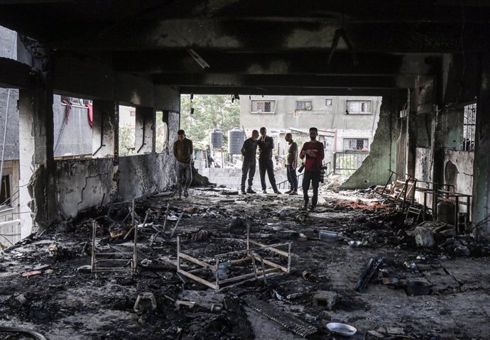 GAZA, May 21, 2025  -- Palestinians check damage after an Israeli airstrike on a school that shelters displaced people, in Gaza City, May 20, 2025.   At least 64 Palestinians were killed in Israeli attacks across Gaza on Tuesday, said Mahmoud Basal, spoke