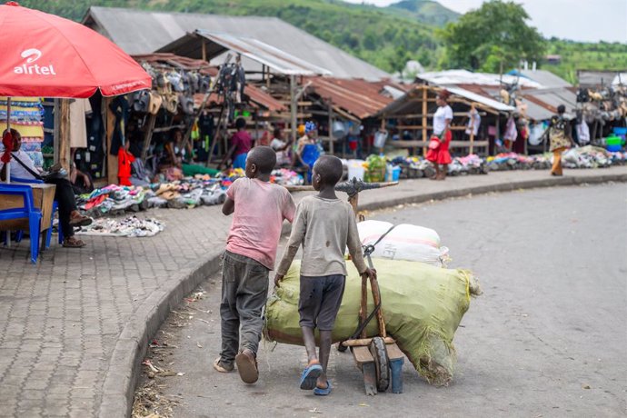SAKE, May 12, 2025  -- Two children transport goods at a local market in Sake, a small town located 27 kilometers from Goma, the capital city of North Kivu province in the Democratic Republic of the Congo (DRC), May 11, 2025.   Many residents of Sake were