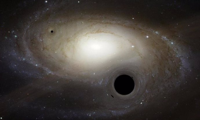Recreación artística de varios agujeros negros de masa intermedia moviéndose en las inmediaciones de una galaxia.