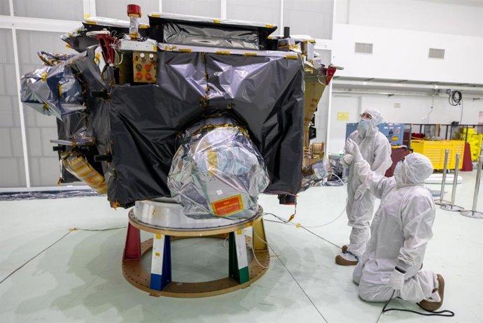 Técnicos removem as tampas protetoras da Sonda de Mapeamento e Aceleração Interestelar (IMAP) da NASA dentro da baia alta da Instalação de Operações Espaciais Astrotech, perto do Centro Espacial Kennedy.