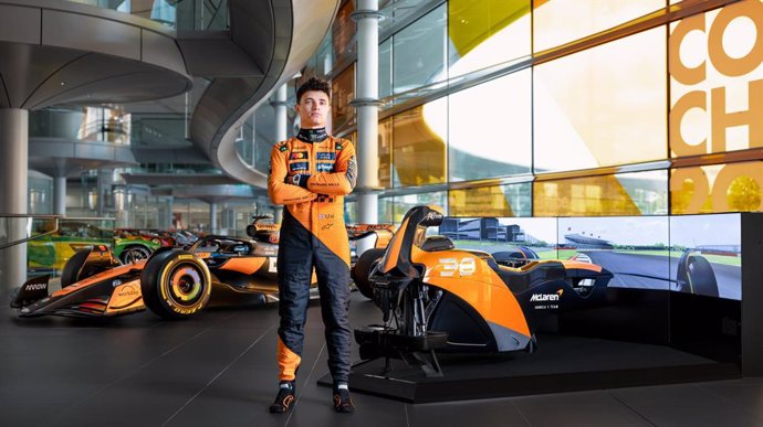 McLaren Formula 1 Team Driver Lando Norris with the McLaren Racing Motion Simulator by Racing Unleashed and the McLaren F1 Team race car at the McLaren Technology Center (MTC) in Woking, UK.