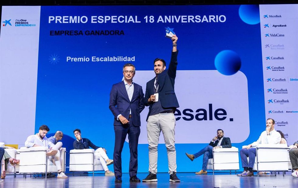 El consejero delegado de TripResale, Eduardo Martínez, recoge el premio de manos de manos del director de CaixaBank Hotels&Tourism, David Rico.