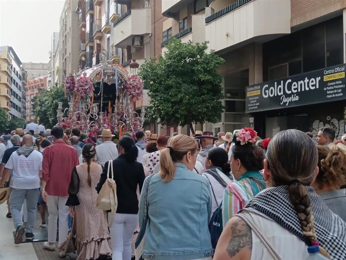 El simpecado de la Hermandad del Rocío de Emigrantes a su paso por la calle Puerto de Huelva.