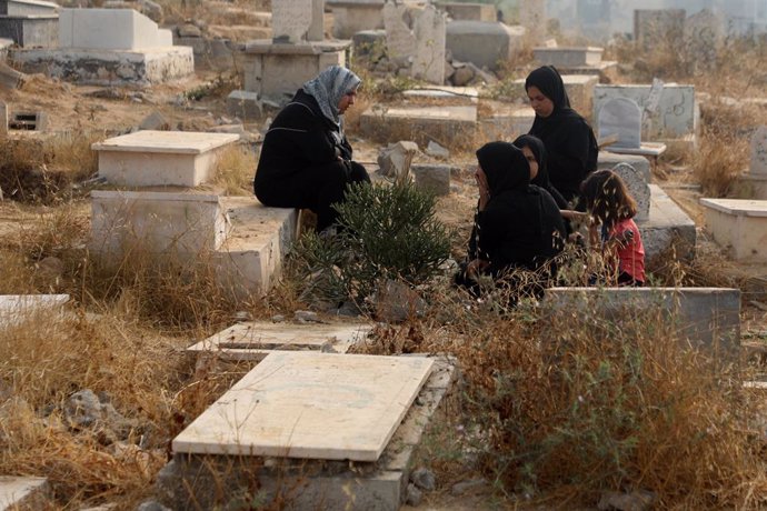 GAZA, June 6, 2025  -- Palestinians mourn over their relatives killed by Israeli army at a cemetery in Gaza City during Eid al-Adha, on June 6, 2025.