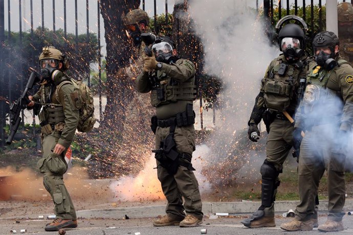 June 7, 2025, Paramount, California, USA: An explosive device detonates behind US Customs agents who fire pepper gas rounds at protesters after an ICE raid in Paramount, California. Immigration and Customs Enforcement has been carrying out operations in t