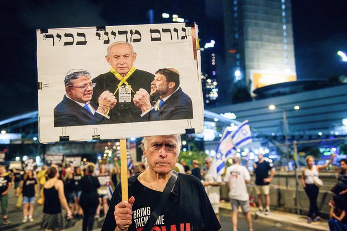 Archivo - Arquivo - 10 de agosto de 2024, Tel Aviv, Israel: Um manifestante segura um cartaz com Bezalel Smotrich e Itamar Ben Gvir estrangulando o primeiro-ministro Benjamin Netanyahu com uma fita amarela que diz: "Figura política sênior" durante a manif