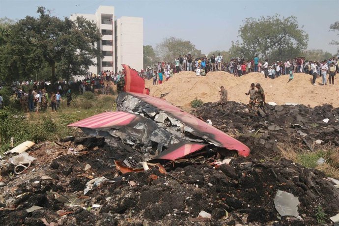 AHMADABAD, June 12, 2025  -- People look at the debris of an Air India plane crashed in Ahmedabad of India's Gujarat state, June 12, 2025.  