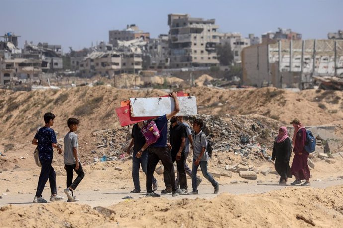 GAZA, June 13, 2025  -- Palestinians are seen in the Sudaniya area, northern Gaza City, on June 12, 2025. The head of the United Nations agency for Palestinian refugees on Thursday condemned the current mechanisms for delivering humanitarian aid in the Ga