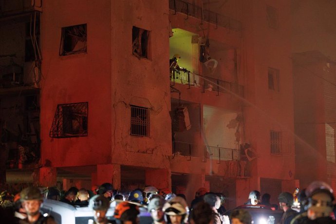 HAIFA, June 16, 2025  -- Israeli security and rescue forces work at the site of an Iranian missile attack in Haifa, northern Israel, on June 15, 2025. Iran launched a fresh aerial attack on Israel on Sunday night, injuring at least two people and igniting