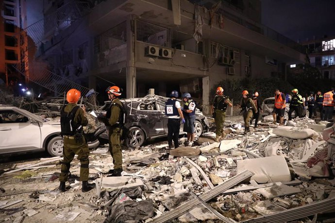 BAT YAM, June 15, 2025  -- Israeli first responders work at a site hit by a missile fired from Iran in Bat Yam, south of Tel Aviv, Israel, June 15, 2025. Iranian aerial attacks killed at least six people and injured 140 others in Israel early on Sunday, I