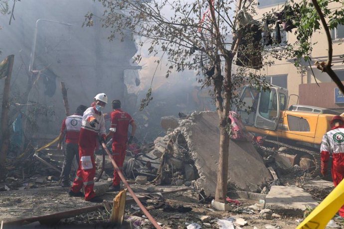 June 14, 2025, Tehran, Iran: Rescue teams are working outside a building that was struck by an Israeli airstrike in Tehran. On June 13, Israel launched airstrikes against Iran, targeting its nuclear and military facilities, as well as residential building
