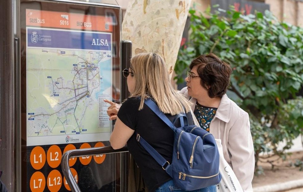 Dos usuarias observan un plano con las rutas de autobús