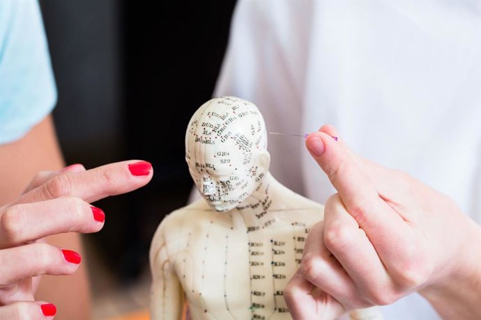 Alternative practitioner explaining acupuncture