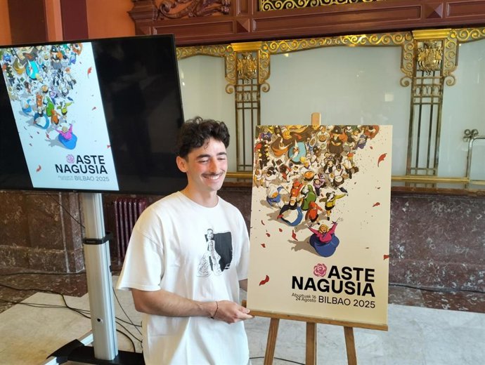 Mario Larrinaga Mochales, ganador del concurso de carteles anunciadores de Aste Nagusia, posando junto a su obra.