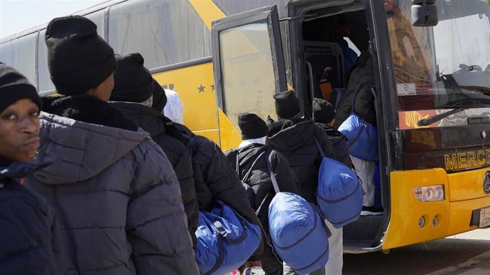 Archivo - Un grupo de migrantes se suben en Trípoli en un autobús para ser deportados