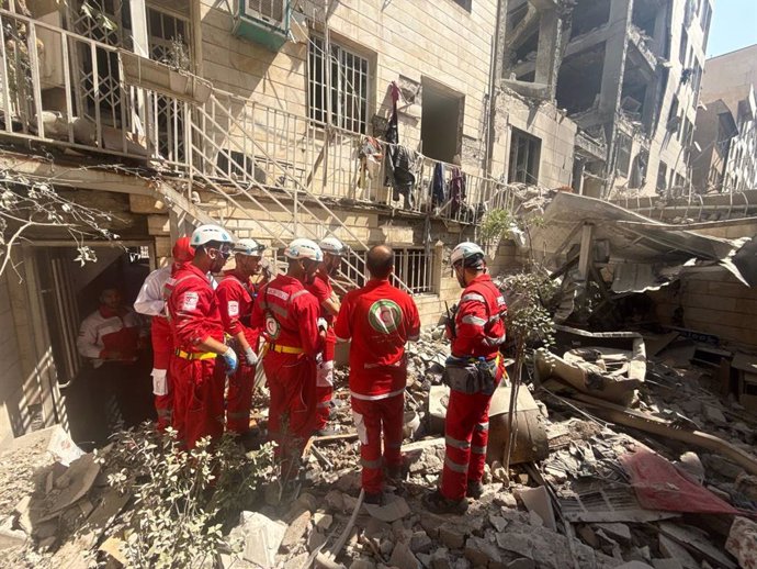June 15, 2025, Tehran, Iran: Rescue teams are currently working outside a building that was hit by an Israeli airstrike. Israel continues to target Iran's nuclear program and energy facilities. On June 14, Israel and Iran exchanged fire following an unpre