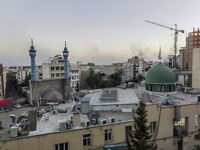 TEHRAN, June 18, 2025  -- This photo taken with a mobile phone shows smoke in Tehran, capital of Iran, June 17, 2025. The Israeli military said over 70 Iranian aerial defense missile batteries and advanced detection radars had been destroyed in five waves