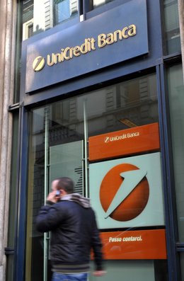 Archivo - FILED - 08 March 2010, Italy, Florence: A passer-by on the phone walks past a branch of the major Italian bank UniCredit in Florence. Photo: picture alliance / dpa