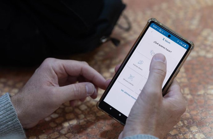 Archivo - Una persona manda un bizum