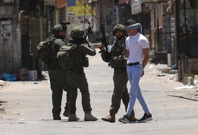 NABLUS, June 19, 2025  -- Members of Israeli forces detain a Palestinian during a military operation in Balata refugee camp, east of Nablus in the West Bank, on June 19, 2025.