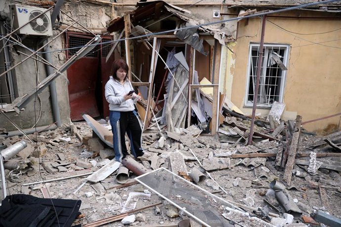 June 17, 2025, Odessa, Ukraine: A woman stands near a residential building that was hit by a drone. Early in the morning of 05/17/2025, the Russian Federation launched a massive attack on the city with attack drones. As of 6.30 am, city authorities report