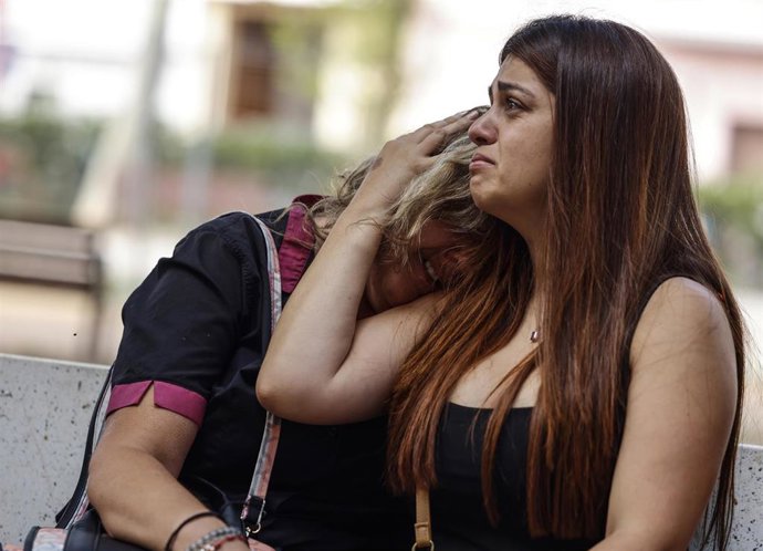 Dos personas se abrazan en el lugar donde han ocurrido los hechos, a 25 de junio de 2025, en Algemesí, Valencia