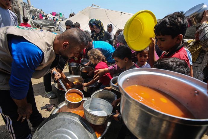 June 1, 2025, Gaza City, Gaza Strip, Palestinian Territory: Displaced Palestinians including women and children wait to receive food distributed by aid organizations in Gaza City, Gaza on June 01, 2025. The situation highlights the growing desperation and