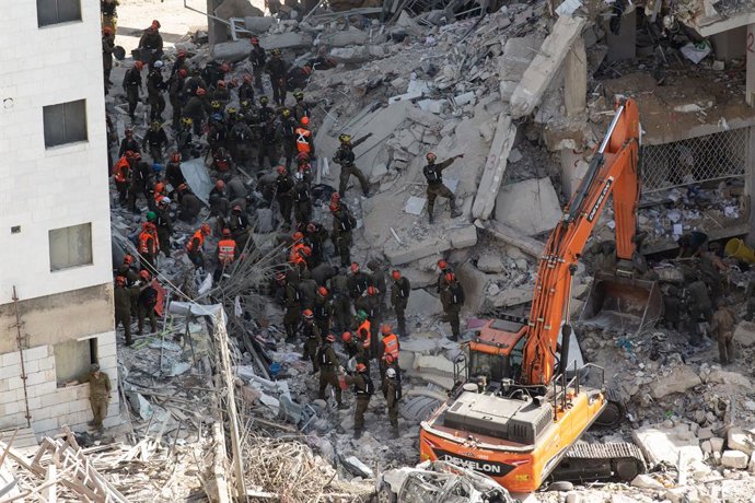 BAT YAM, June 16, 2025  -- Israeli security and rescue forces work at the scene where buildings were damaged by a missile fired from Iran in Bat Yam, central Israel, on June 15, 2025. According to Israel's state-owned Kan TV News, the death toll from Iran