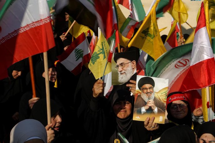June 25, 2025, Beirut, Beirut, Lebanon: Pro-Iranian Hezbollah supporters raise pictures of Iranian supreme leader Ayatollah Ali Khamenei and assassinated party leader Hassan Nasrallah during a rally near the Iranian embassy in Beirut to celebrate what the