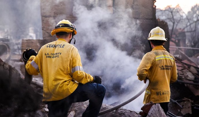 January 10, 2025, Pacific Palisades, California, USA: LA Fire fighters put out hot spots on a property already destroyed in the Eaton Fire.