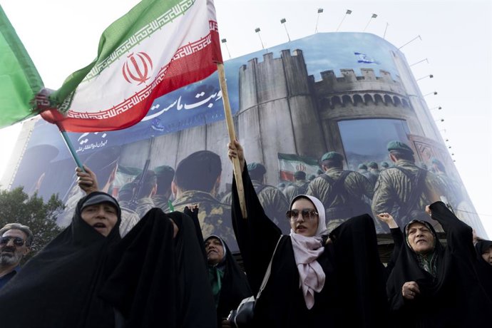 June 22, 2025, Tehran, Tehran, Iran: a woman protestor waves an Iranian flag a during a protest following U.S. attacks on nuclear sites, in a square in central Tehran on sunday, Jun 22, 2025.