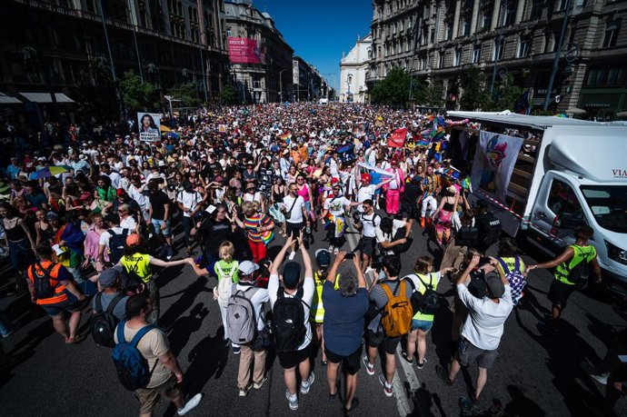 28 June 2025, Hungary, Budapest: People walk the streets of Budapest with their sign during the 30th Budapest Pride Parade. Photo: Daniel Alfoldi/ZUMA Press Wire/dpa