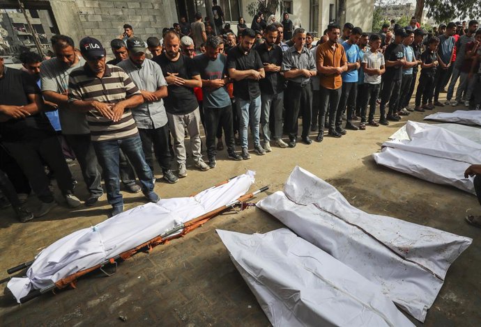 GAZA CITY, July 2, 2025  -- Palestinians pray over victims who were killed in Israeli airstrikes, at a hospital in Gaza City, July 1, 2025. At least 45 Palestinians were killed by Israeli shelling and gunfire in the Gaza Strip on Tuesday, Gaza's Civil Def