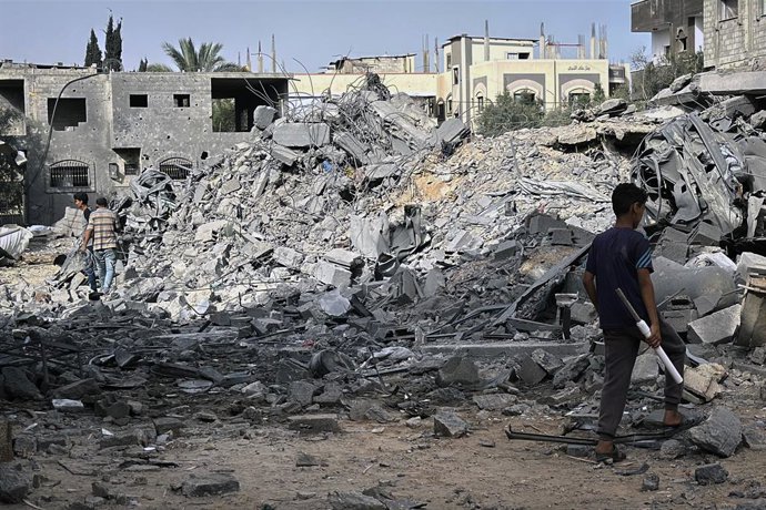 July 1, 2025, Dair El-Balah, Gaza Strip, Palestinian Territory: Palestinians inspect the rubble of the Al-Aimawi family's home, destroyed by Israeli airstrikes in Al-Zawaideh, central Gaza Strip, on Tuesday, July 1, 2025